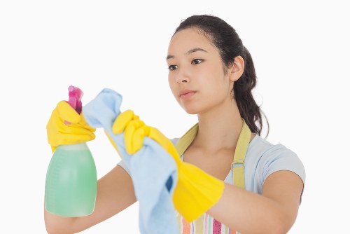 Technician performing deep sofa cleaning in a living room